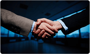 Executive shaking hands after securing a confidential leadership role
